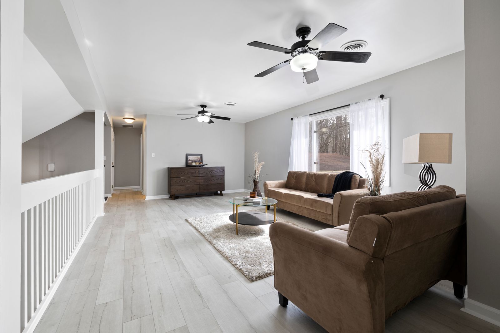 Layered Persian rug over dark flooring in a moody sunroom