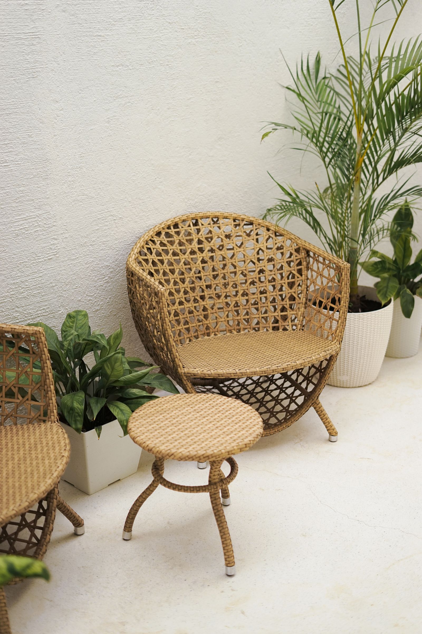 Black rattan and wicker furniture in a dark sunroom